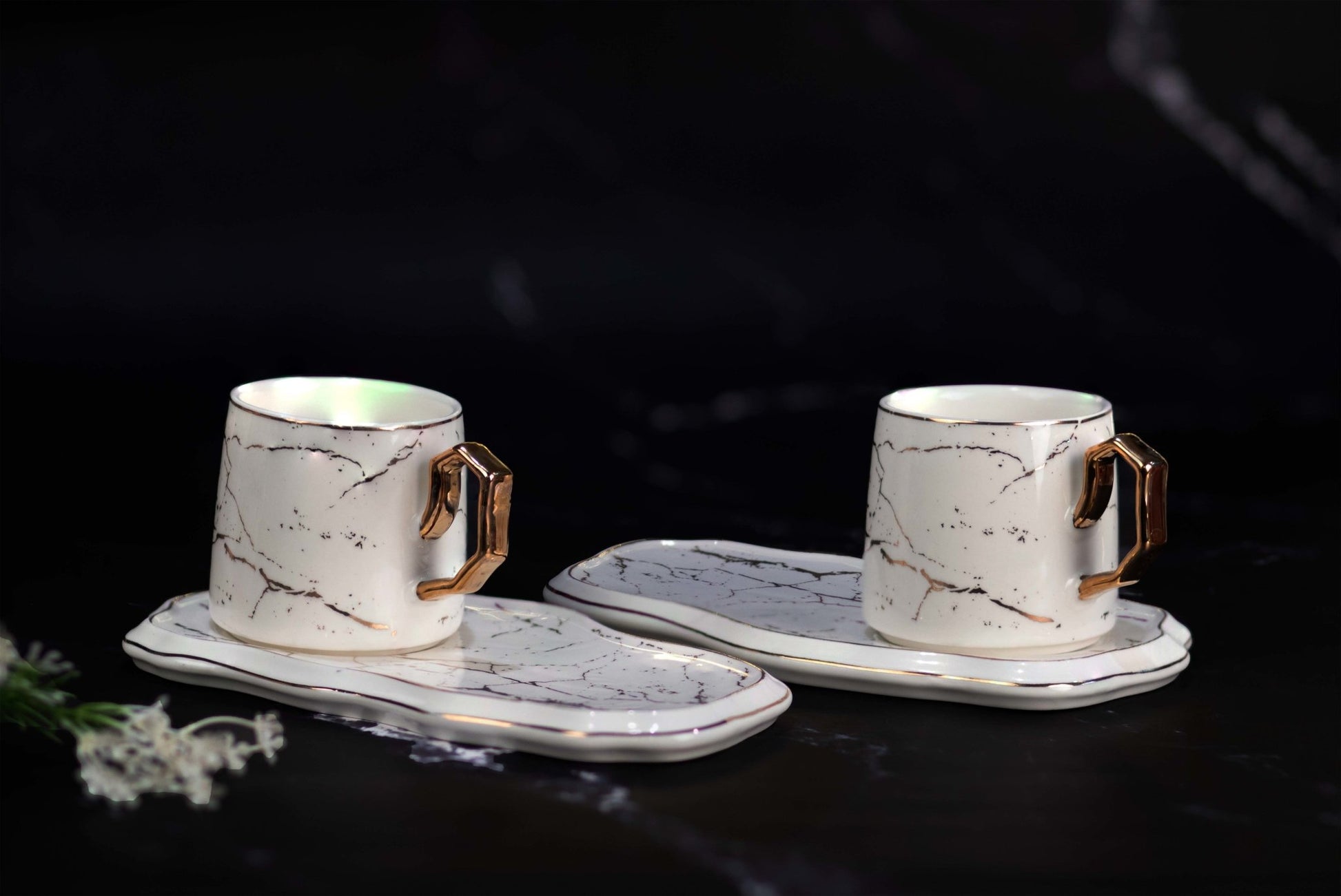 two white cups with plate